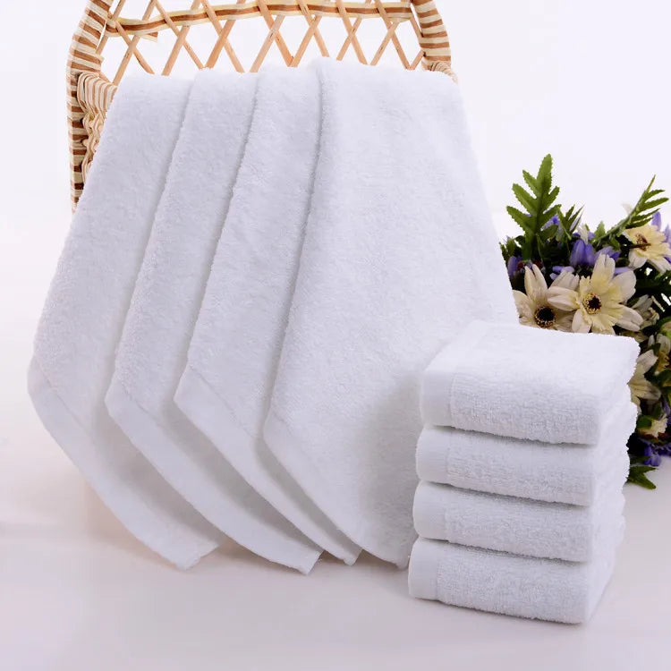 Petites serviettes visage blanche pendue sur un meuble de salle de bain